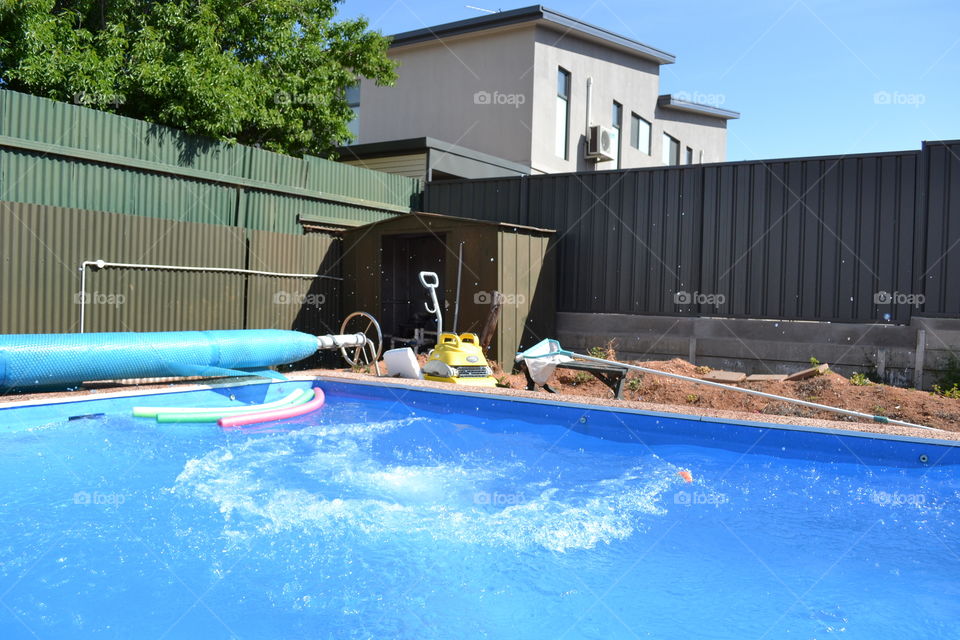 Water movement after a dive in a swimming pool outdoors 