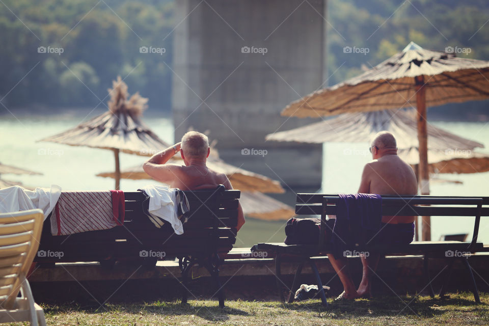 Two elder men enjoying last sunny days 