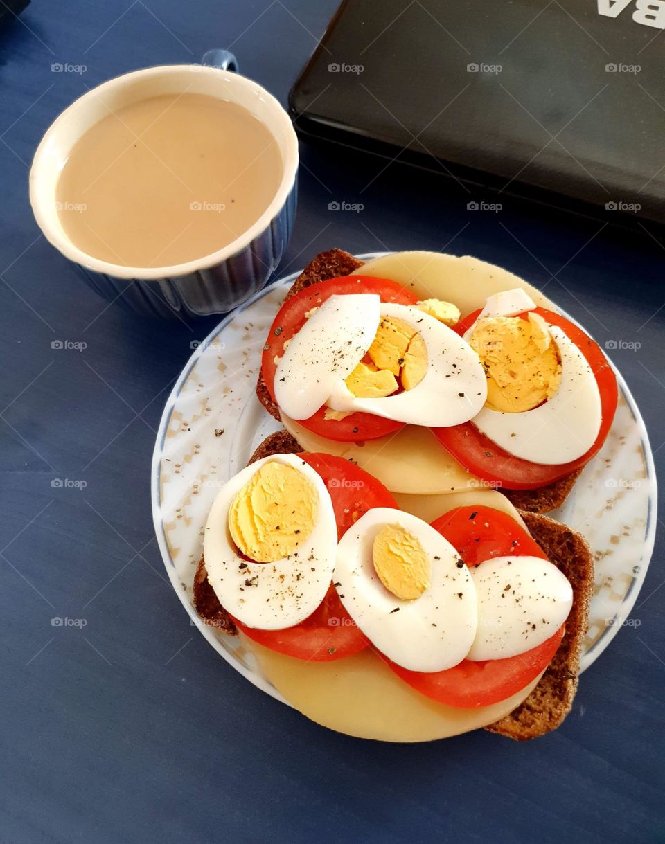 Nice cup of coffee with sandwiches for a breakfast.