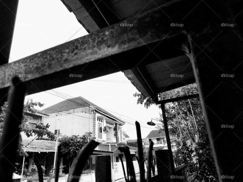 From behind the iron fence