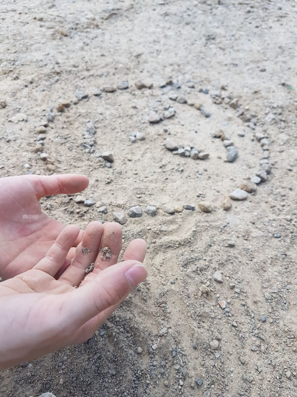 kids hand with little stones