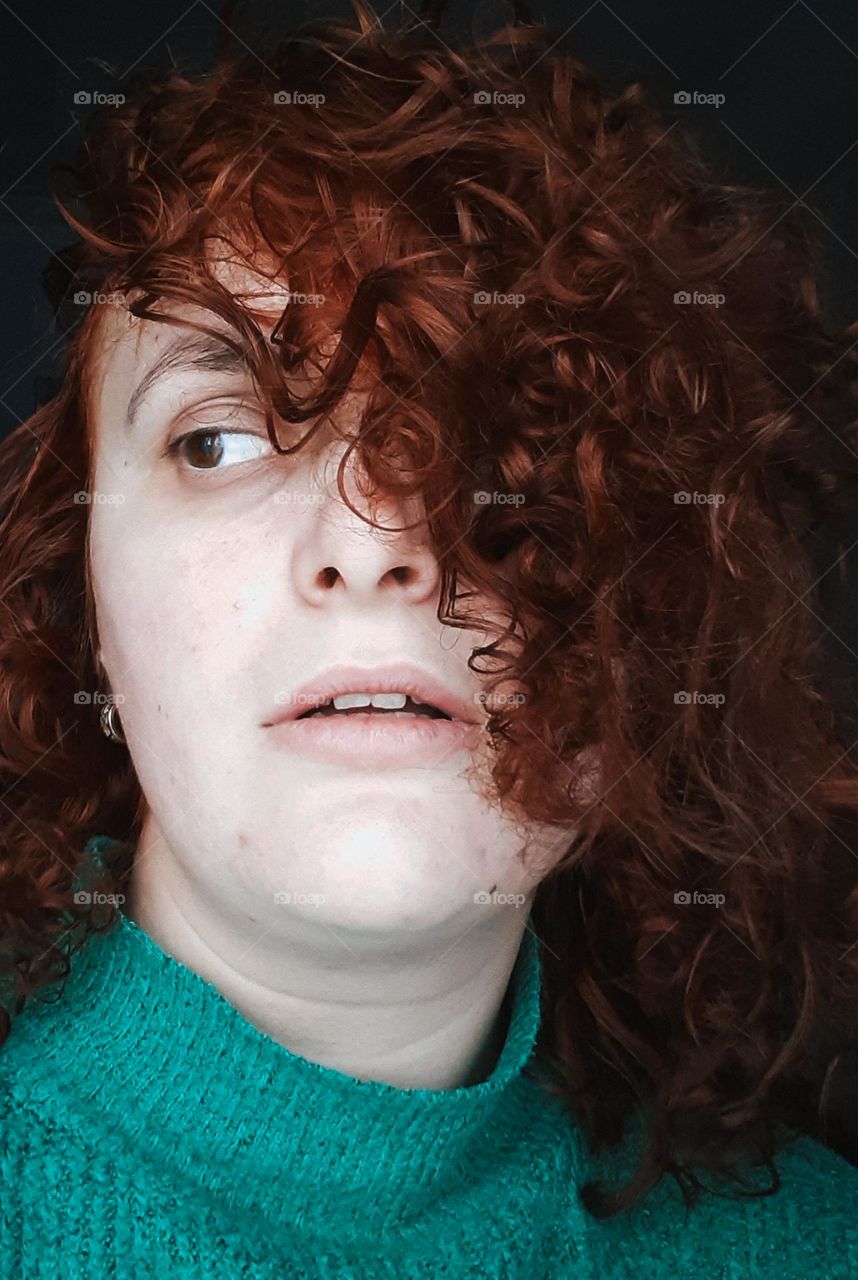 Face of a red-haired girl with curly hair