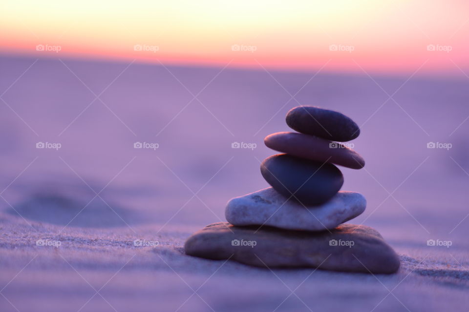 Stack of pebble on sand