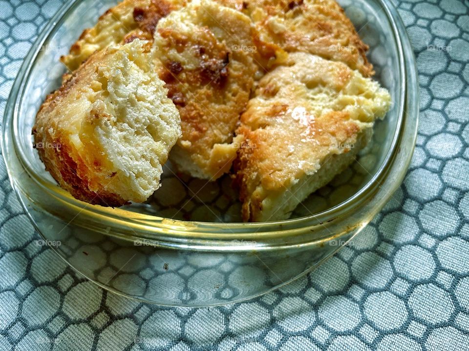 Sweet homemade yeast pastries lie on top of each other on a glass plate