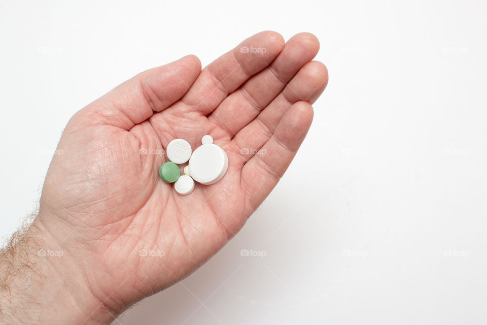 Medicine Pills In Hand Isolated In White Background
