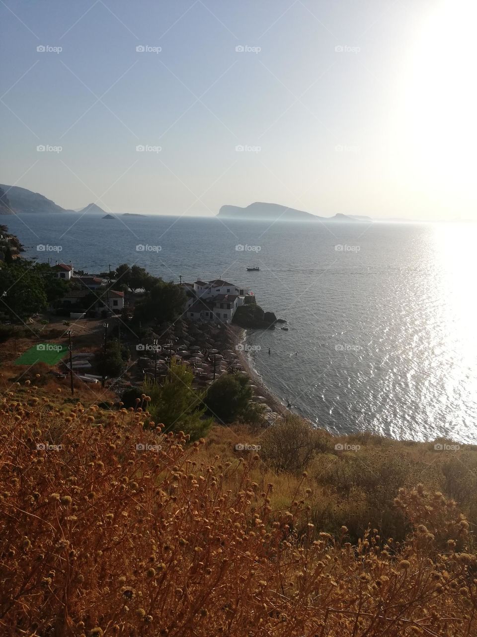 Going to a peaceful beach of a greek island in the middle of the summer.