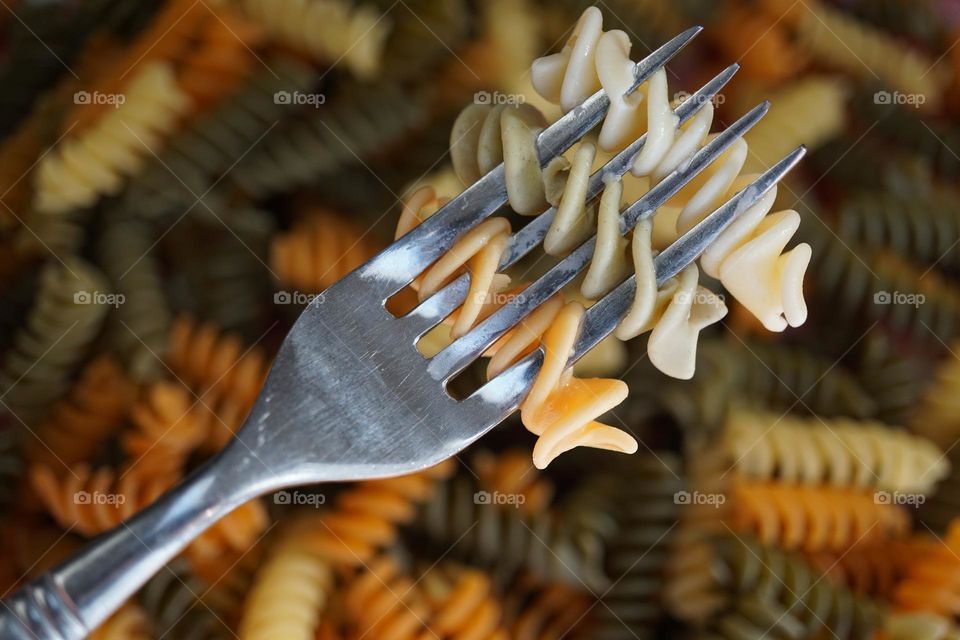 Fork entwined in Fusilli pasta 