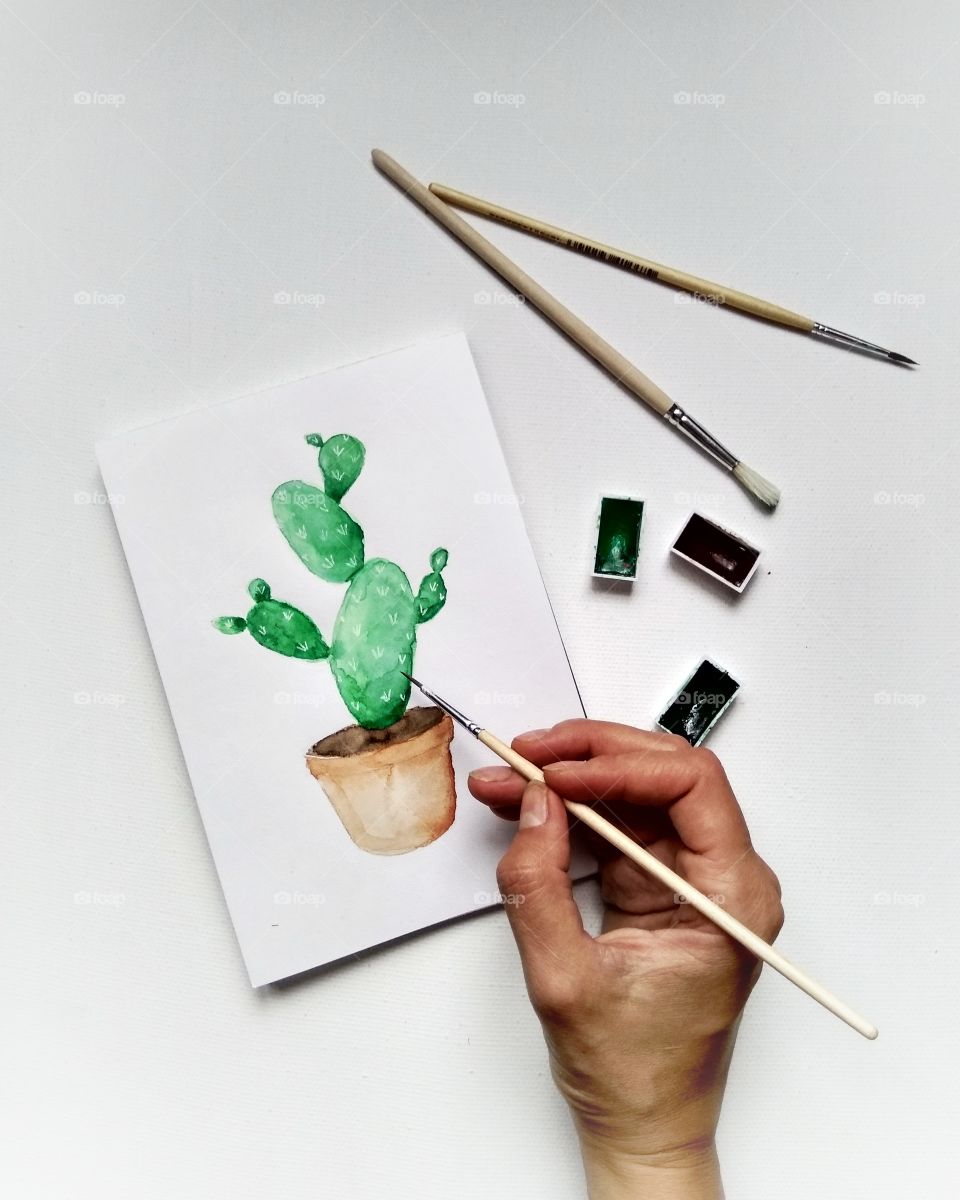girl grawing a cactus water color