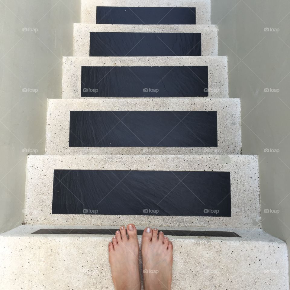 Female feet on outdoor stone stairs