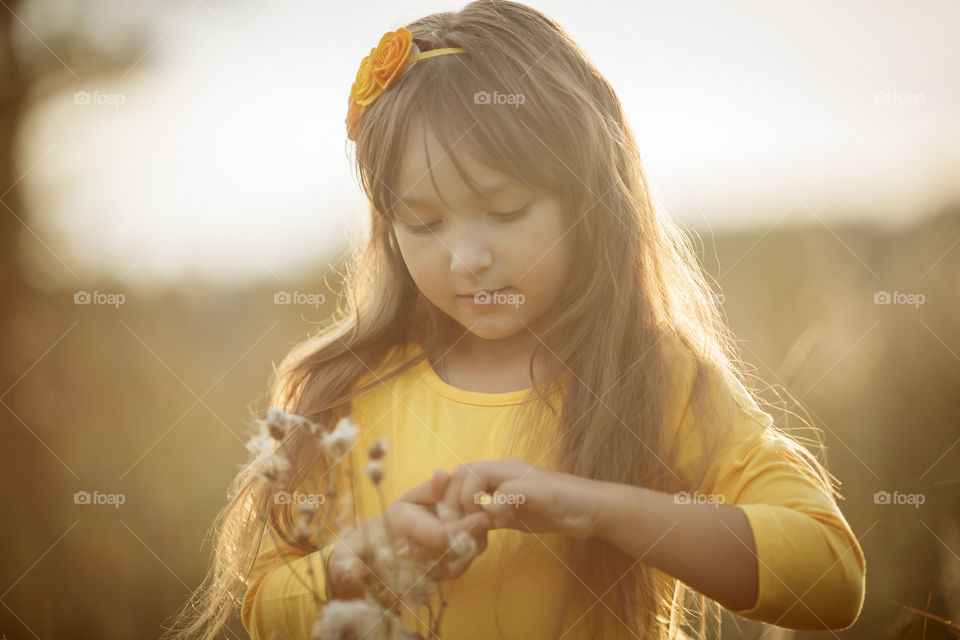 Little girl in yellow dress outdoor portrait 