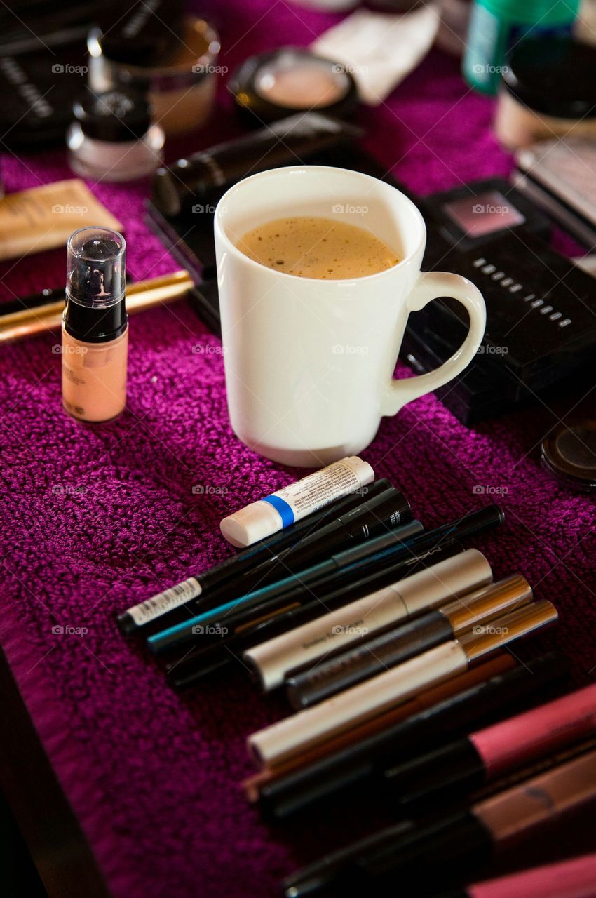 Coffee and make up are essentials to my daily routine. Image of make up, brushes and a cup of coffee.