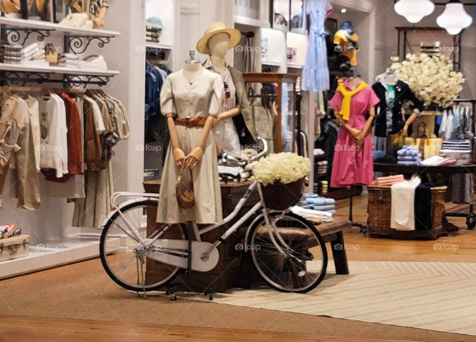 White bicycle and wooden mannequins in the mall