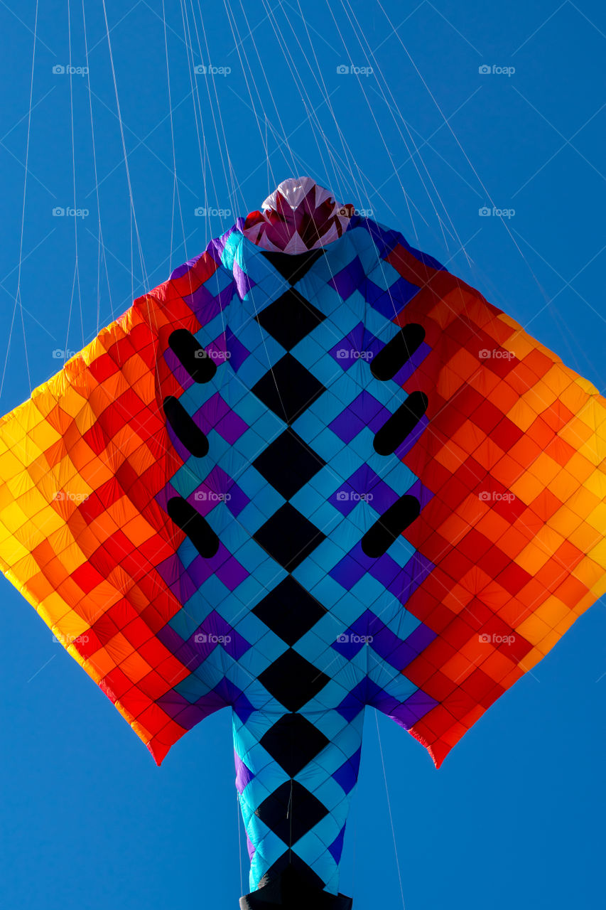 colorful kite dance with wind on clear blue sky