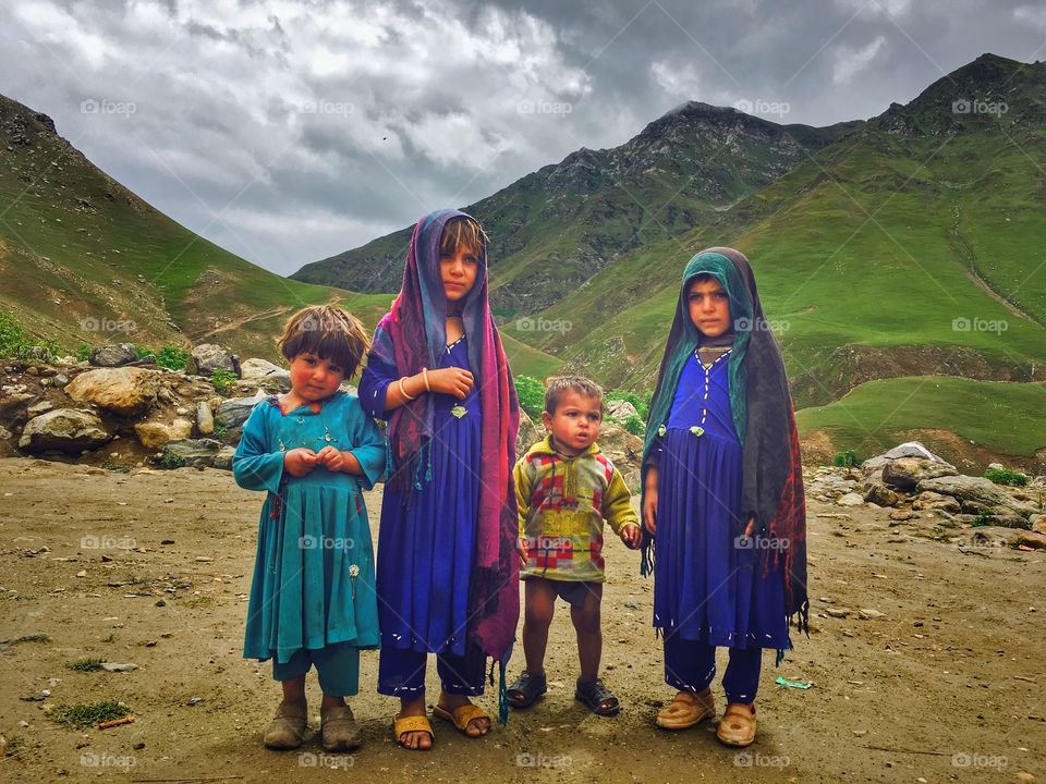 Group of children standing in front of mountain