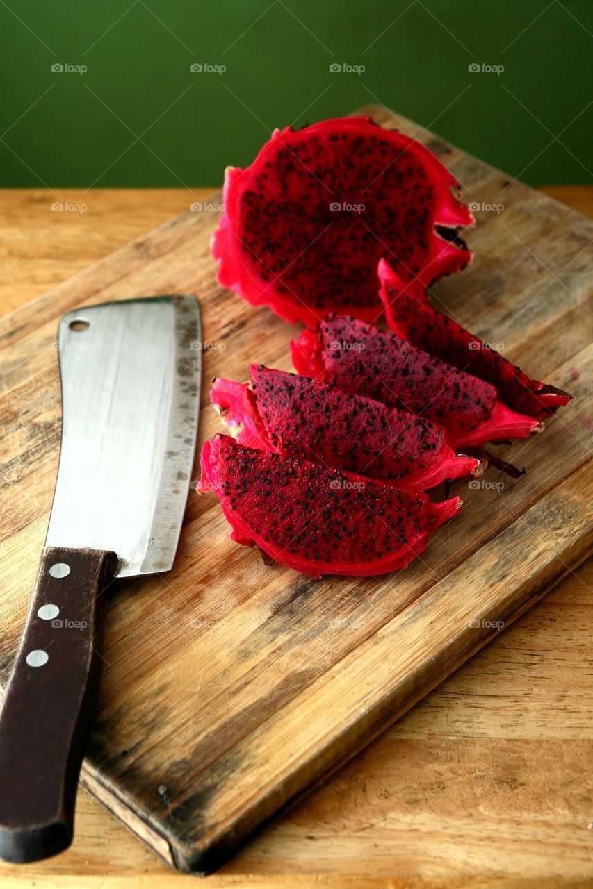sliced dragon fruit on a wooden chopping board
