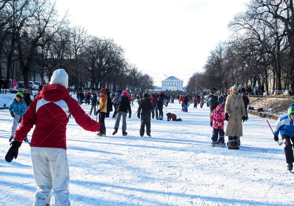 People ice-skating on snow covered field