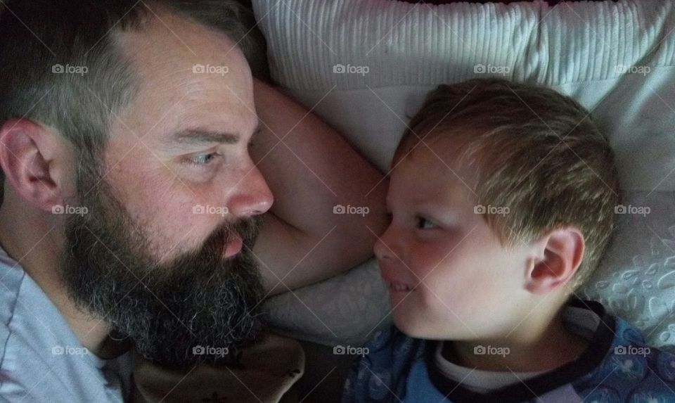 Early morning at bed father and son