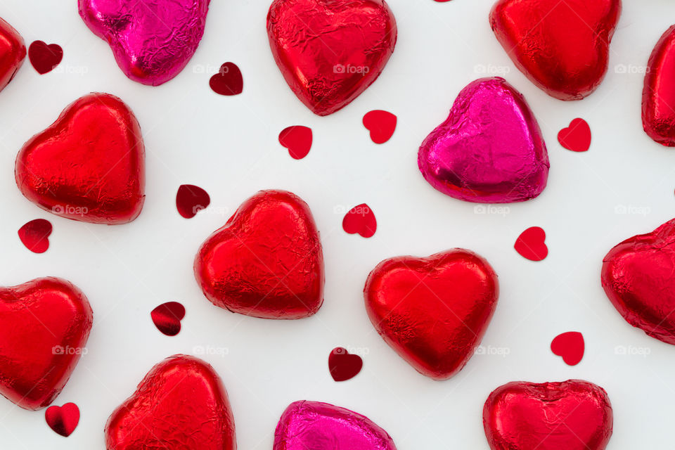 Heart shaped Valentine chocolates on a white background.