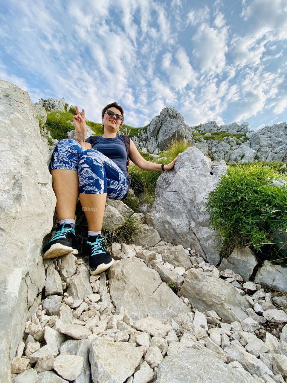 Ground up photo of the happy young woman traveling in the mountains in spring in Slovenia hills