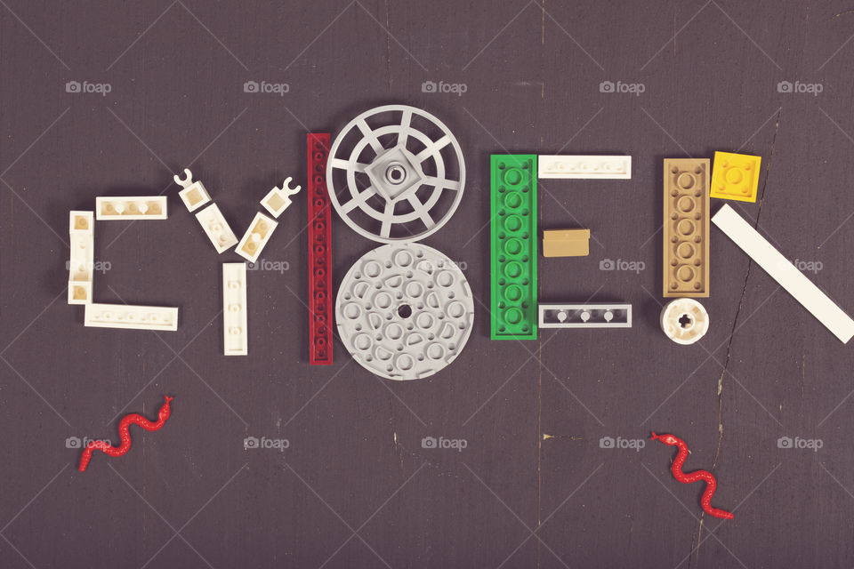 The word CYBER composed og pieces of LEGO. Flat lay. Vintage style.
