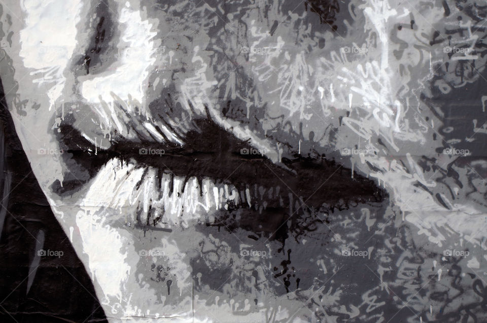Close-up of painted female lips on brick wall in Berlin, Germany.