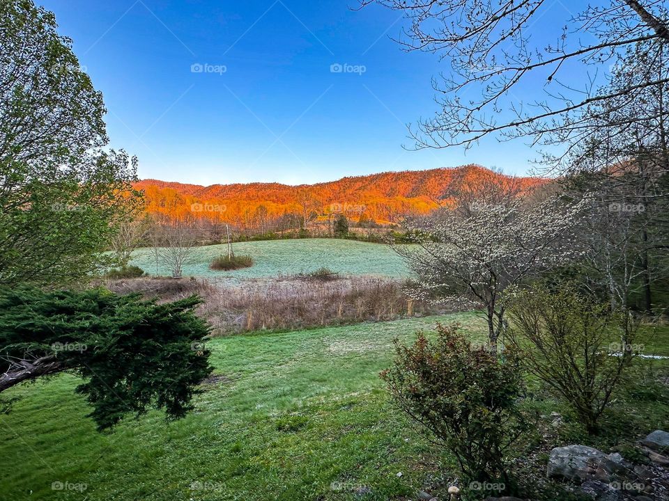 Sunrise rays reflection on a mountain