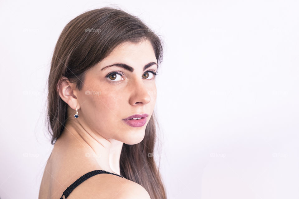 Beautiful woman looking at camera against white background
