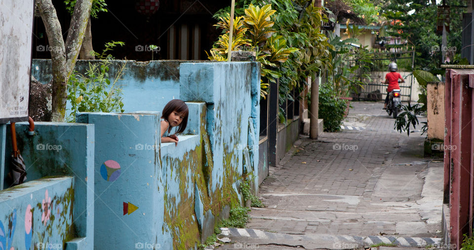 A little girl in a quiet street of Jogjakarta, Java, Indonesia 