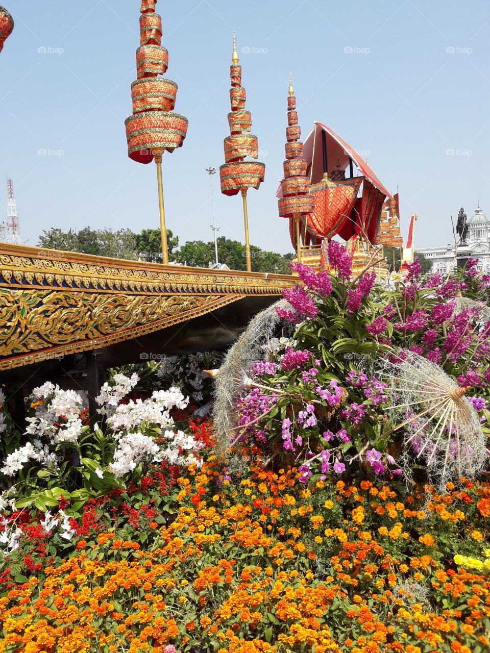 the beauty of flower decoration beside tha"Suphannahong Royal Barge Model" , beautiful carving , many tiered umbrella and special pavillion.