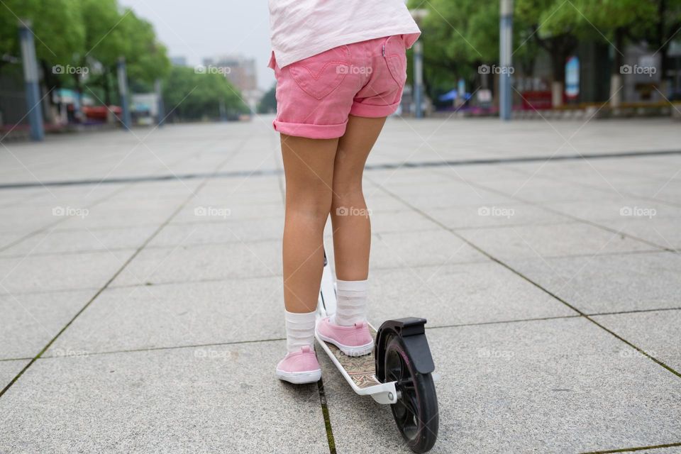 Girl riding on scooter 