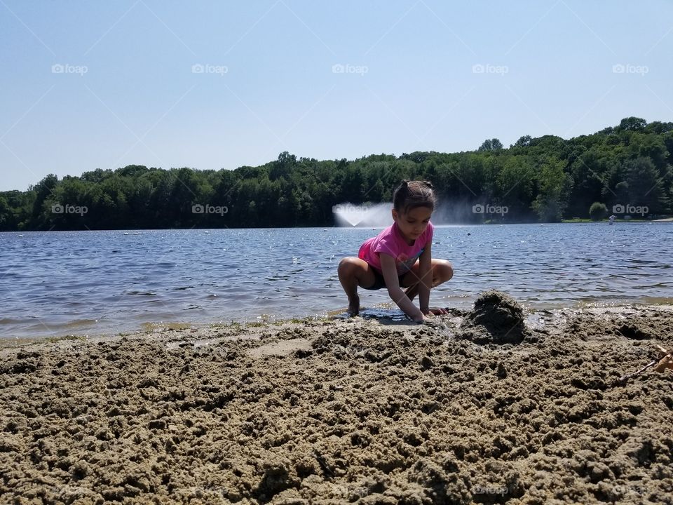 girl building sand castles