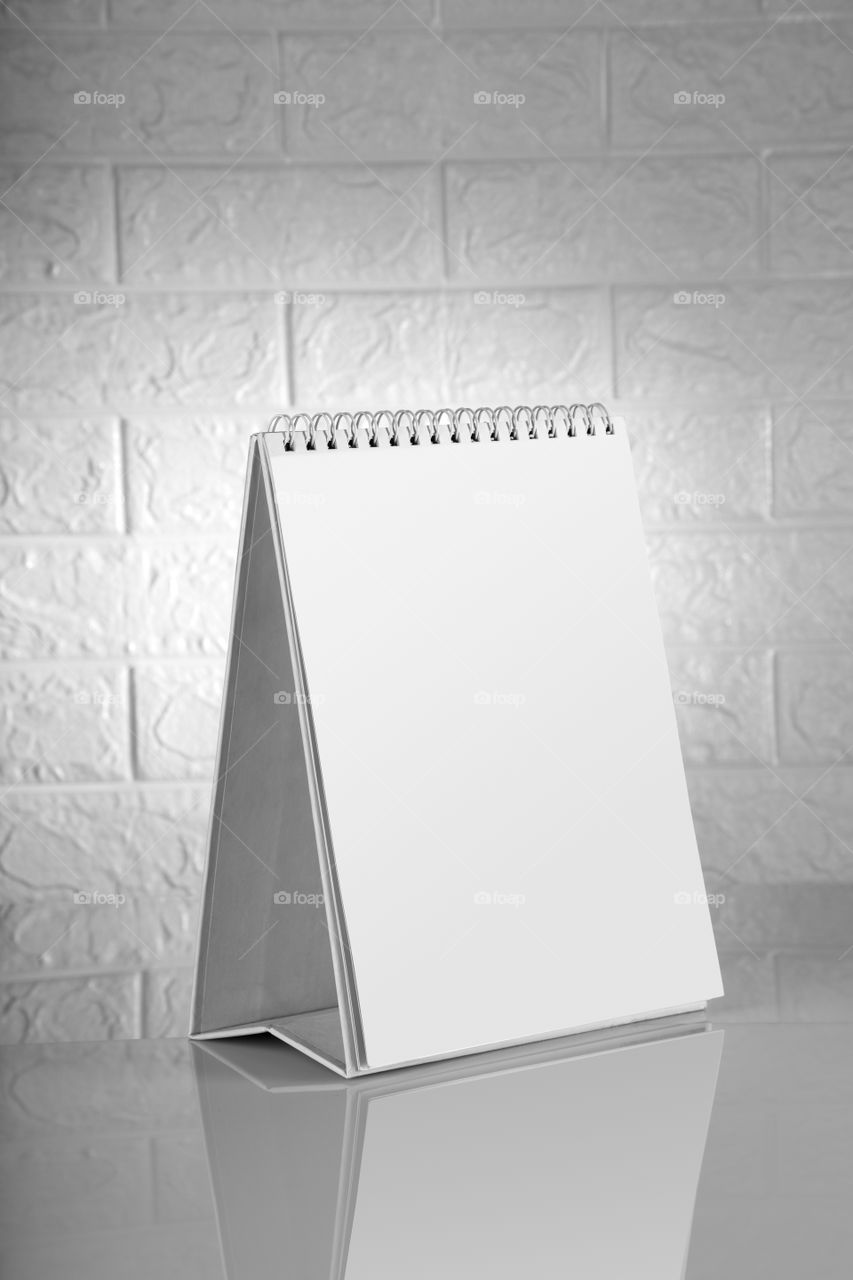 Blank white Calendar mockup on a brick wall backdrop