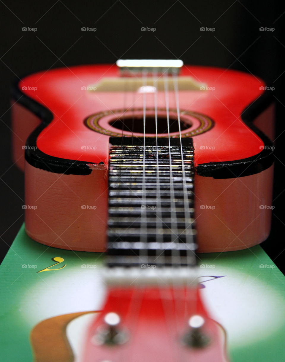 A little red toy guitar