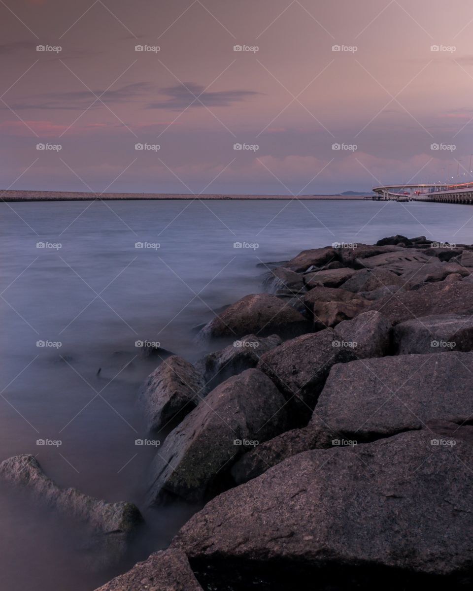 Rocky Shoreline of the City at Dusk