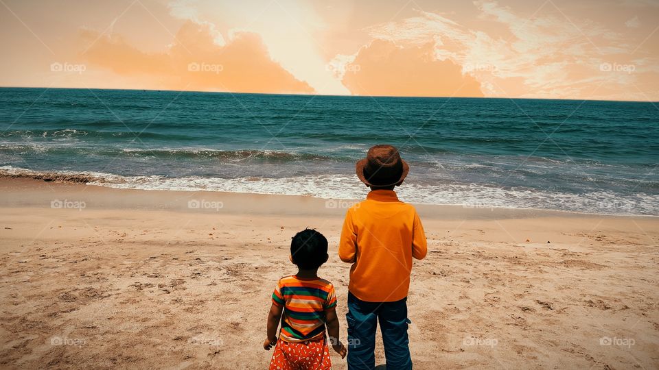 Enjoying Beach sunset with little brother in evening