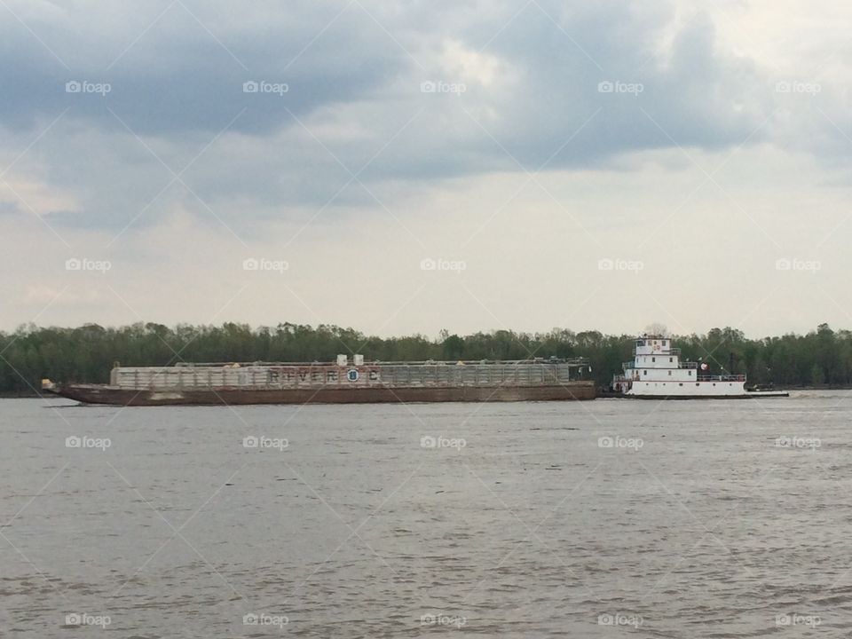 Tugboat pushing barge upstream. 