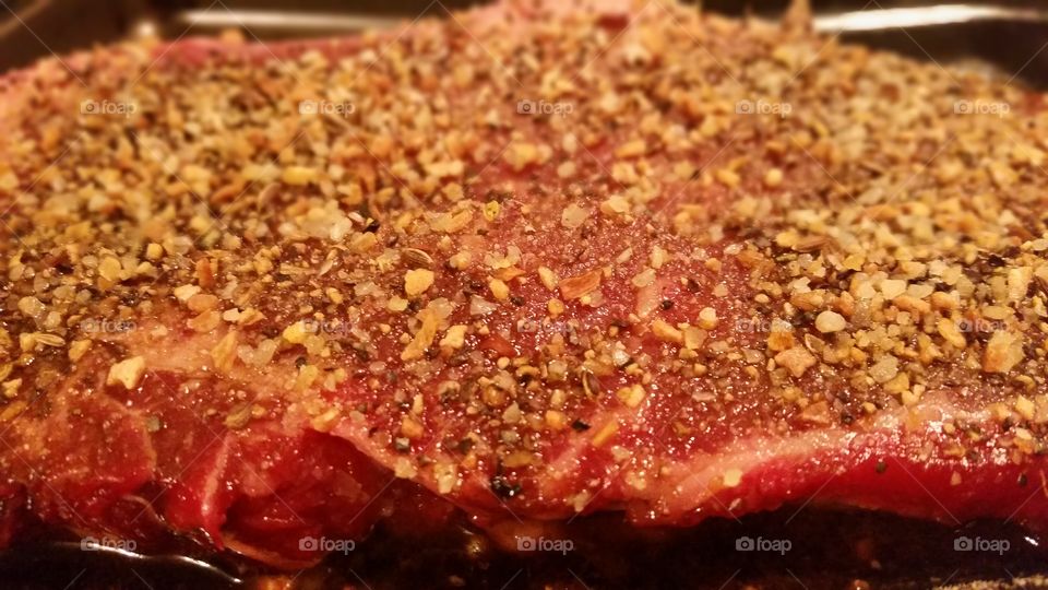 spiced steak ready for the grill