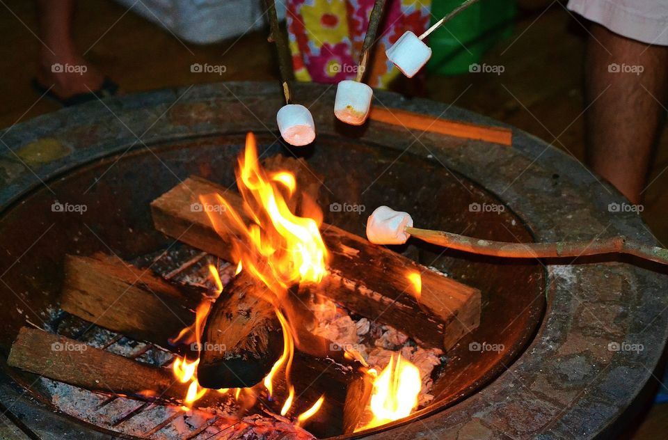 Close-up of people's roasting marshmallows