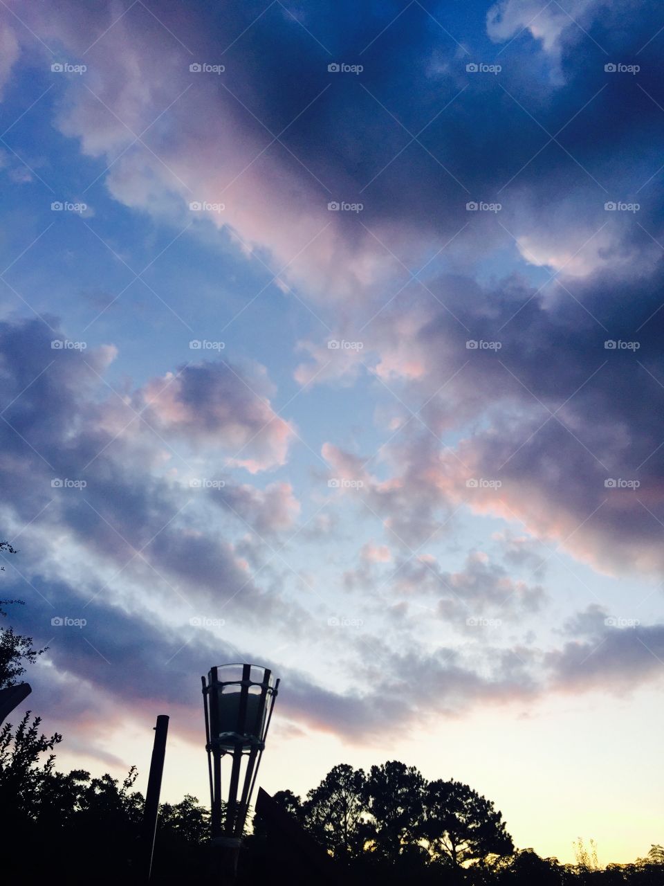 A beautiful evening sky after solar eclipse showing clouds with gray, lavender, pink looking quite lovely. 