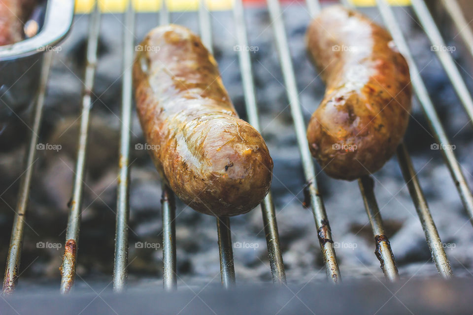 Summer BBQ, grilling sausages with beer