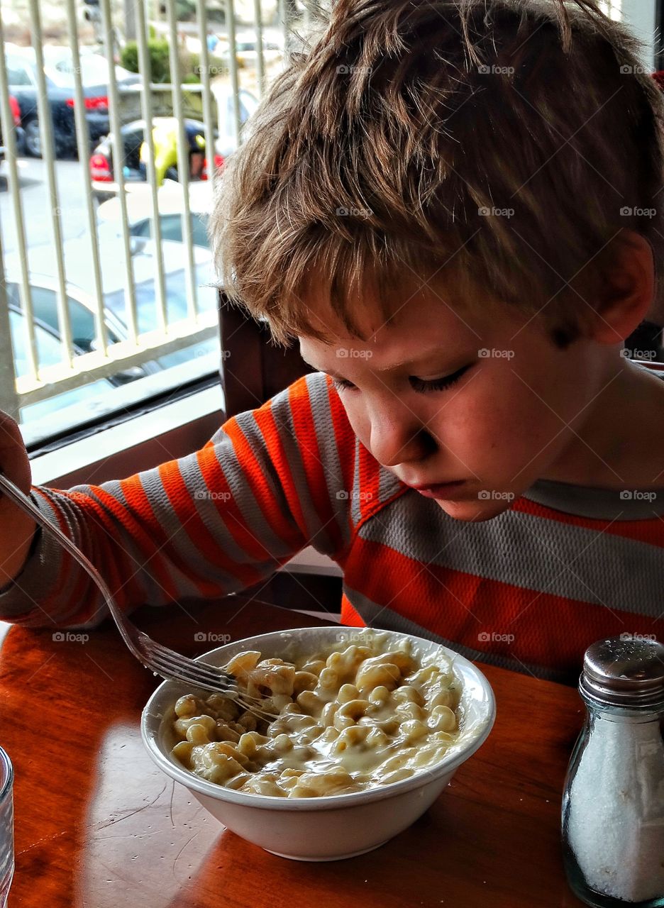 Young Boy Eating. Young Boy Eating Macaroni And Cheese
