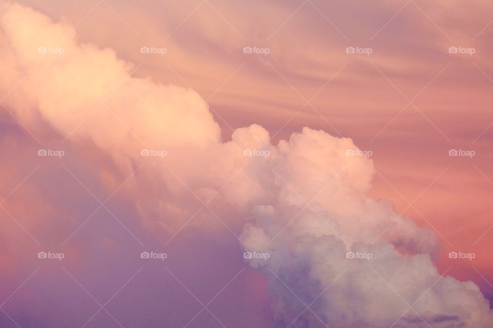Expanding cumulonimbus clouds against a beautifully painted sky 