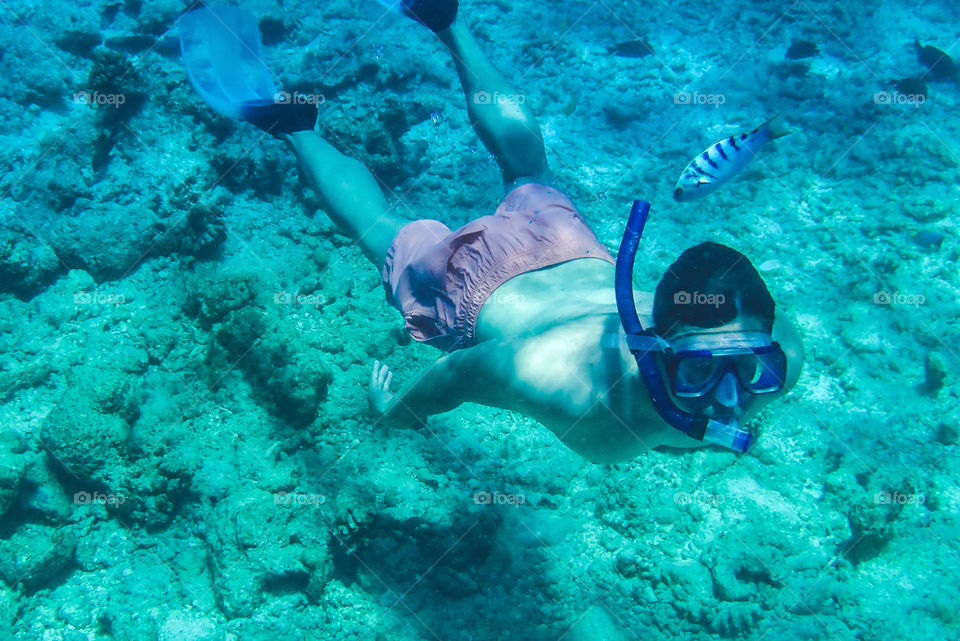 Man Snorkeling on a summer vacation to the Maldives 