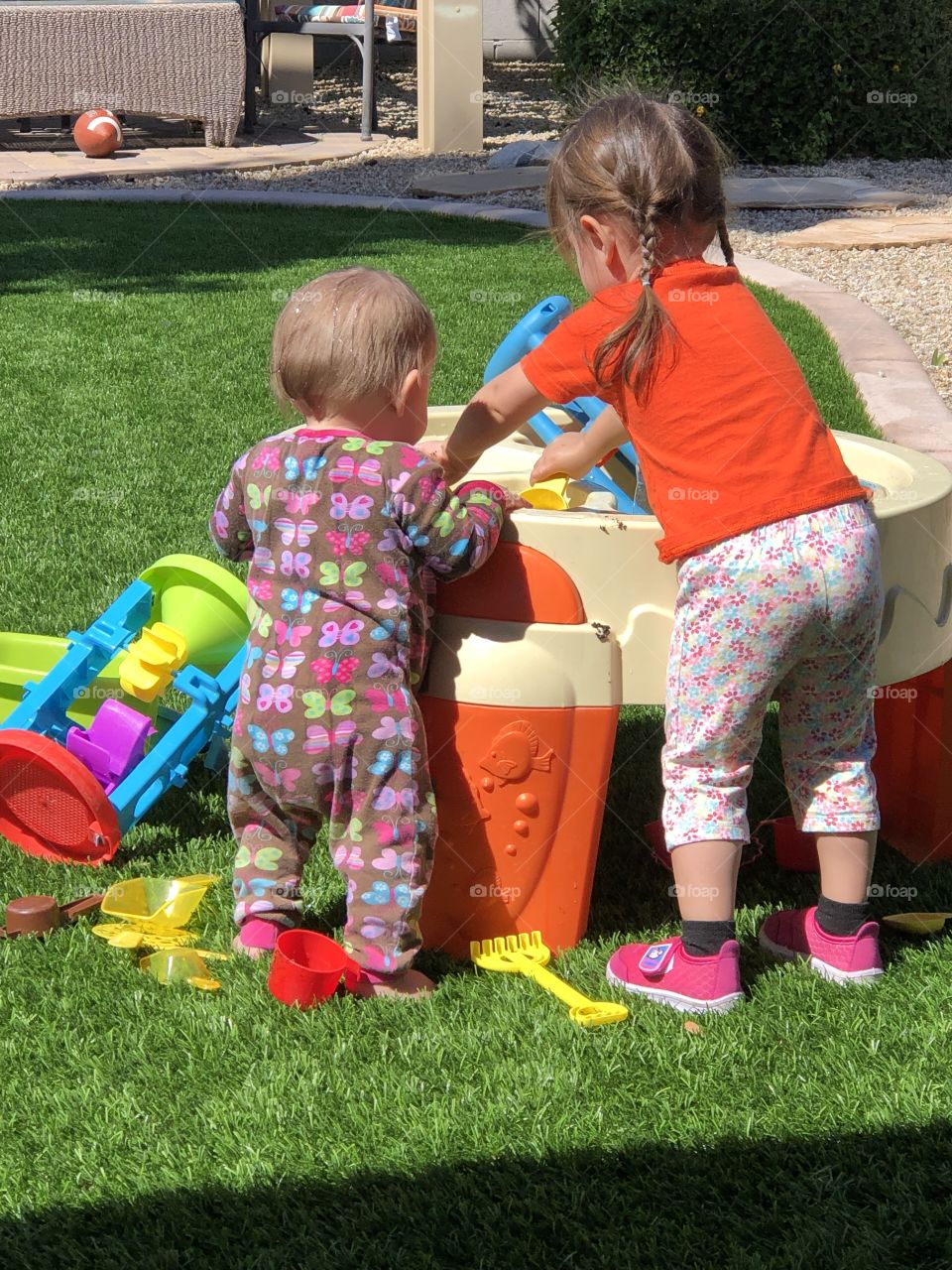 Baby and toddler playing at water table
