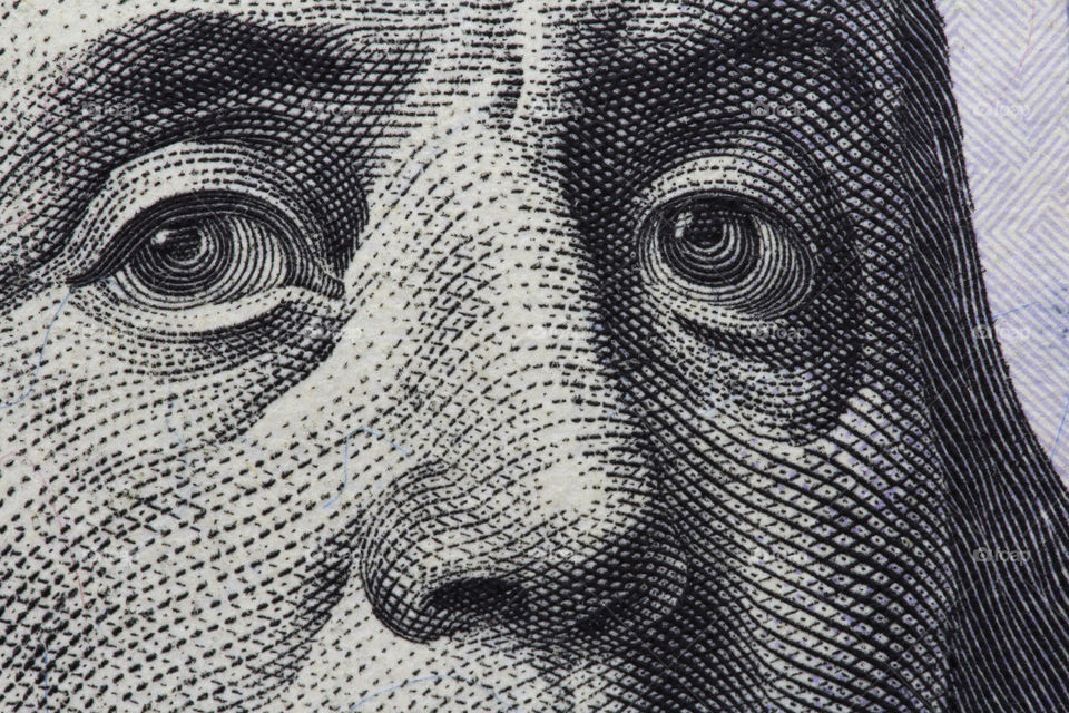 Benjamin Franklin's look on a hundred dollar bill.  portrait of the Benjamin Franklin , macro usa dollar banknote or bill