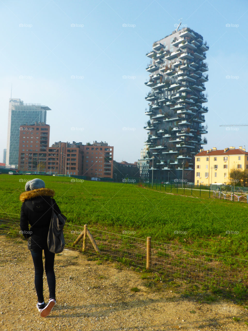 Tourist im the park is looking the strange building called vertical forest 