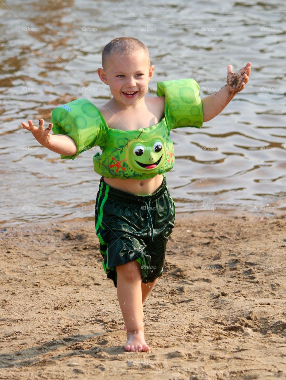 Boy in swimmies at pond