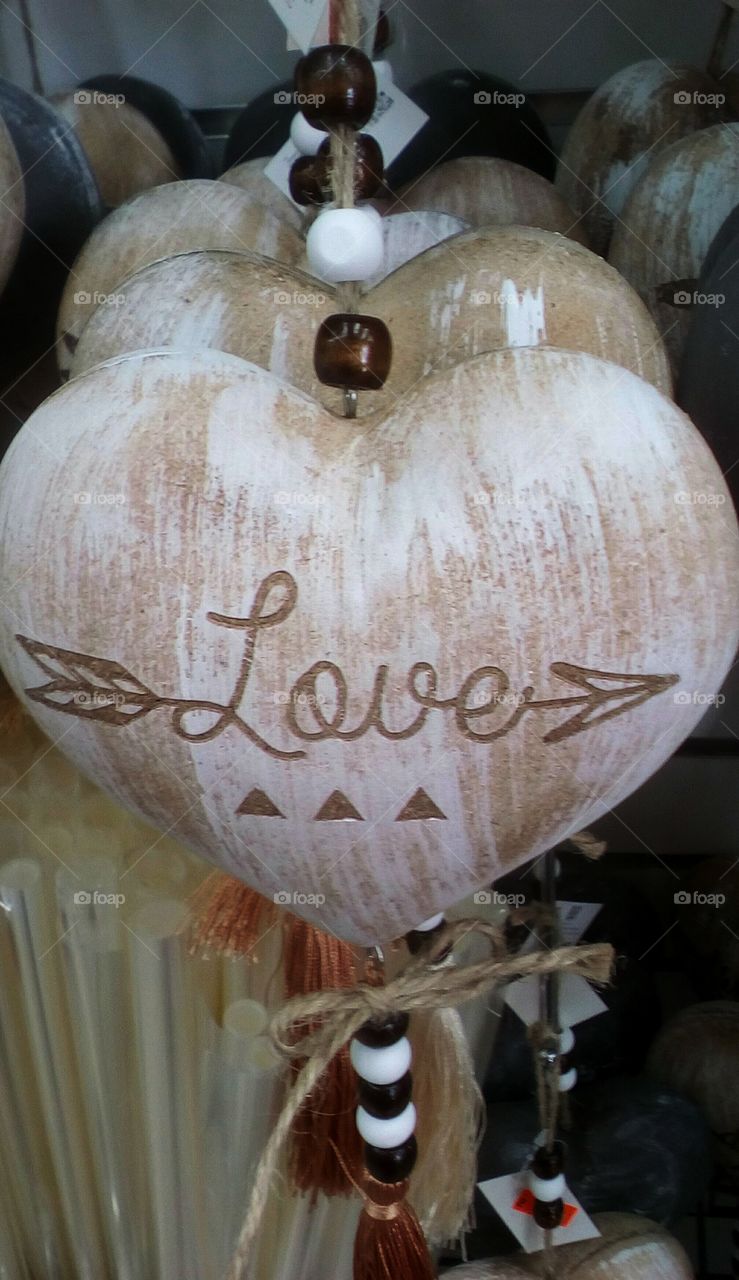 Wood heart with text "Love" hanging in
shop /store