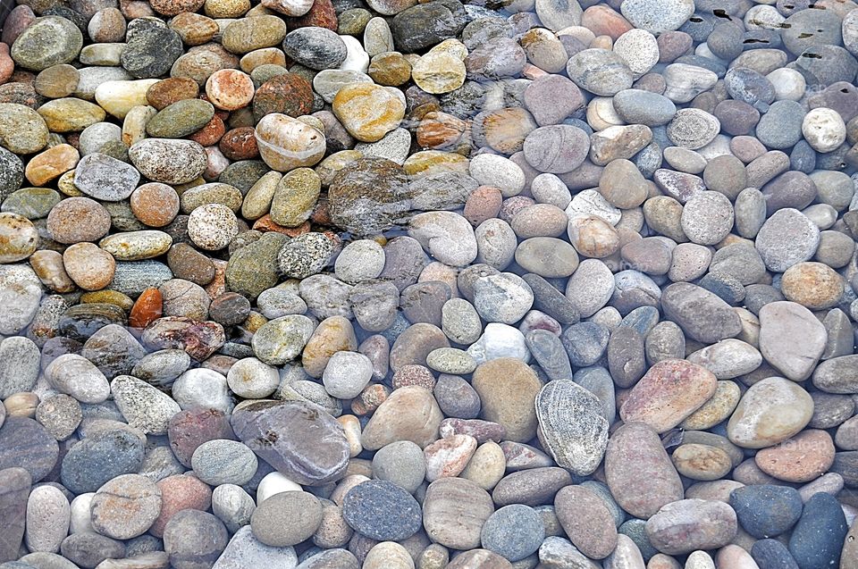 texture with stones partly wet in sea water and partly dry