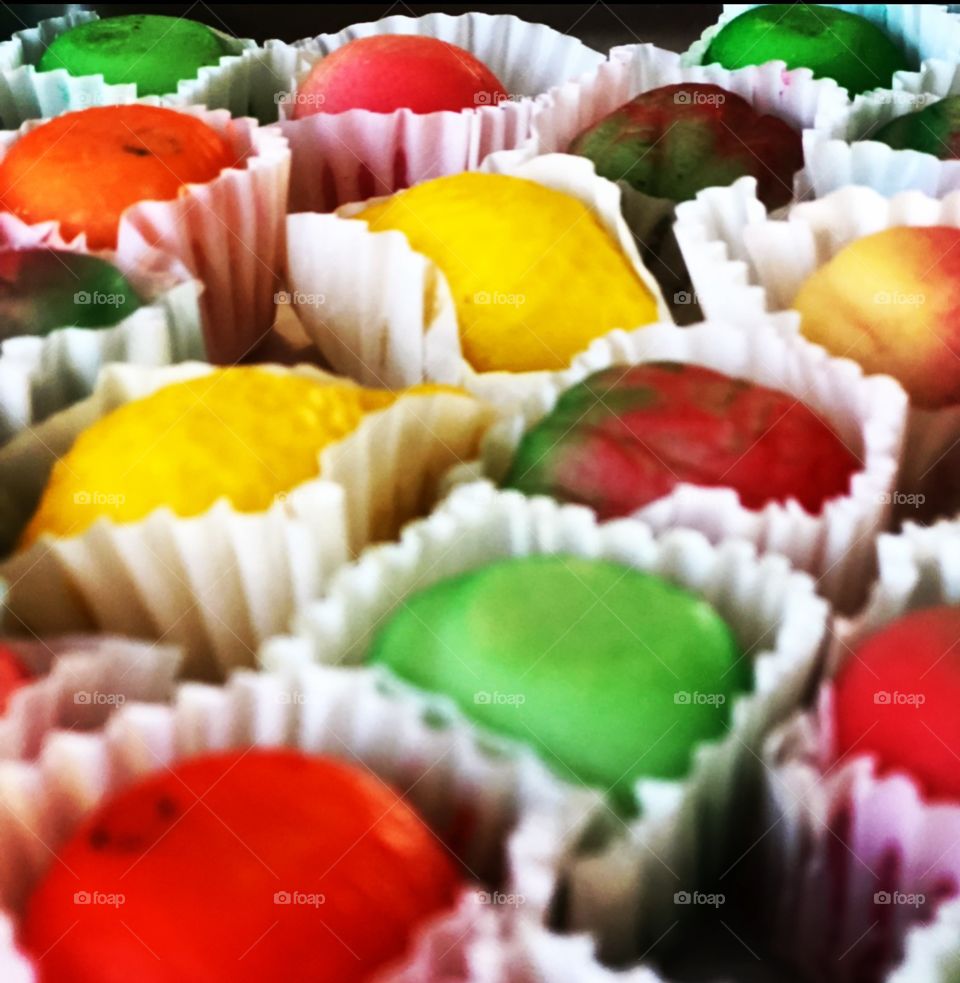 Marzipan fruit confections in white paper war appears 